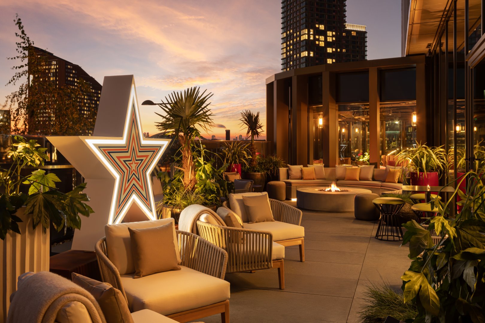 A terrace at the Gantry Hotel decorated with many lighting elements and seating.